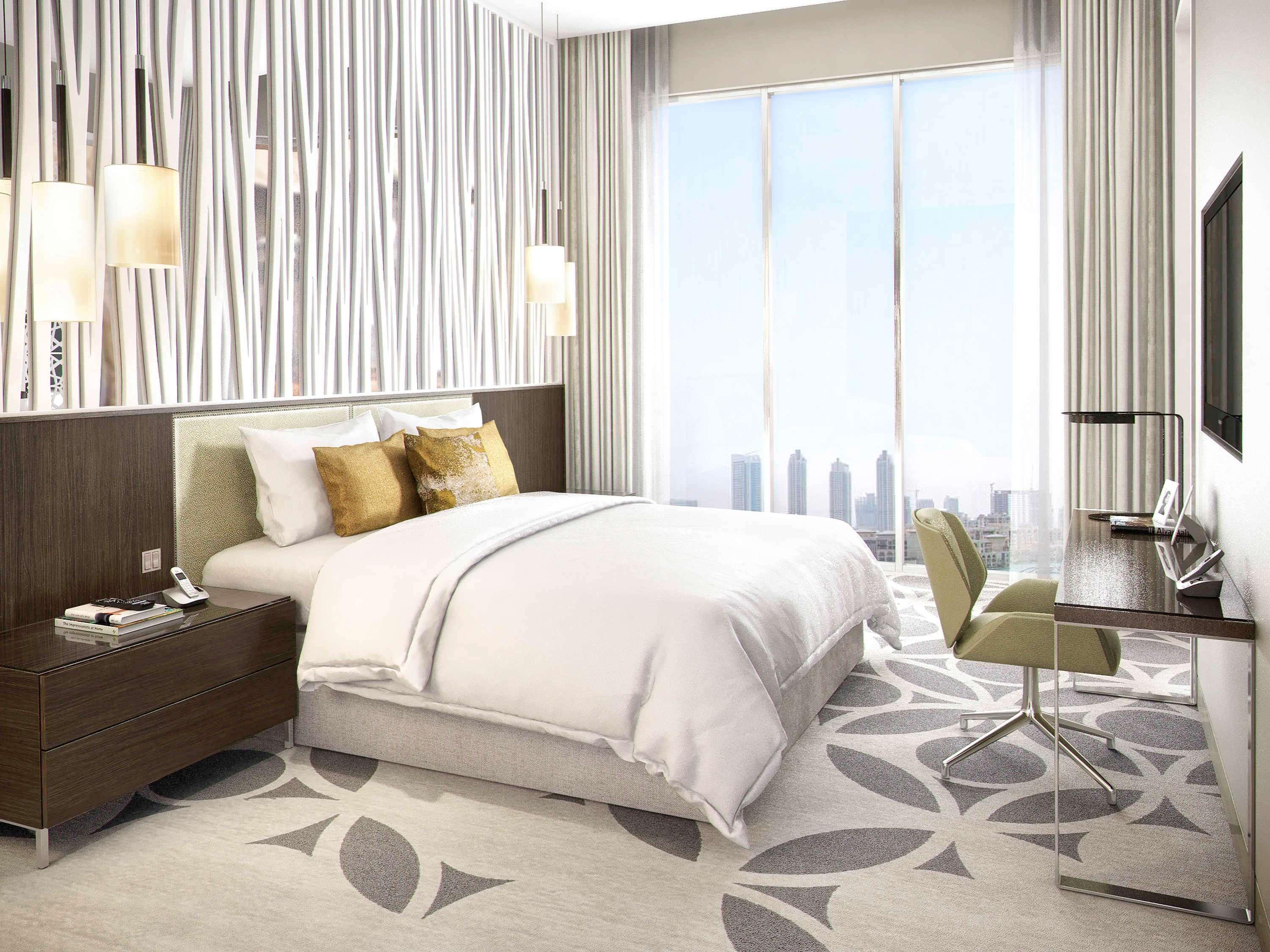 Grand Mercure Dubai City Exterior foto The photo shows a modern hotel room with a clean and stylish design. It features a large bed with white linens and decorative pillows. Beside the bed, there's a dark wooden nightstand. On the opposite side, there is a small work desk with a chair, an